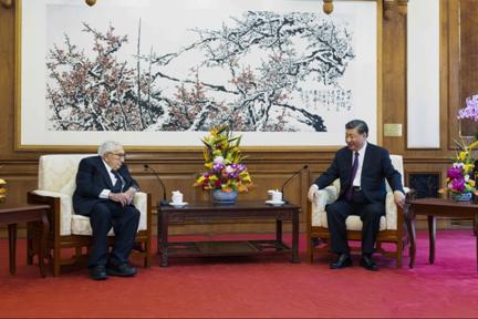Chinese President Xi Jinping, right, talks to former U.S. Secretary of State Henry Kissinger during a meeting.