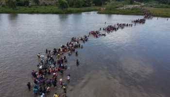 Aerial view of Salvadorean migrants heading in a caravan to the US, crossing the Suchiate River to Mexico, from Ciudad Tecun Uman, Guatemala, on November 02, 2018. Photo by CARLOS ALONZO/AFP via Getty Images