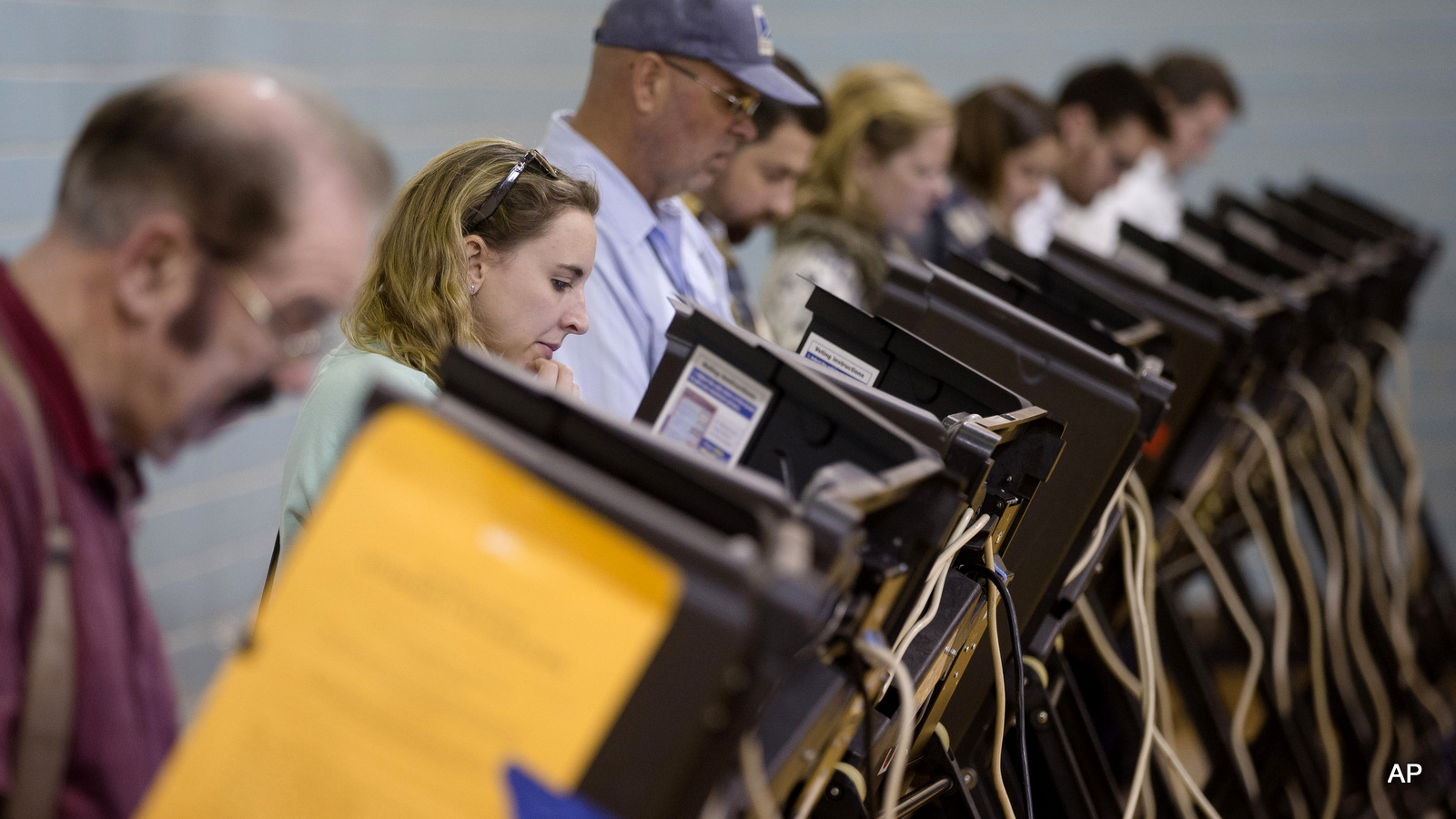 Voters use electronic voting machines at the Schiller Recreation Center polling station on election day, Tuesday, Nov. 3, 2015, in Columbus, Ohio.