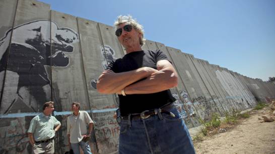 Composer and former bassist and singer of British rock band Pink Floyd Roger Waters, is seen while touring Israel's apartheid wall in the West Bank refugee camp of Aida in Bethlehem, Tuesday, June 2, 2009. (AP/Muhammed Muheisen)