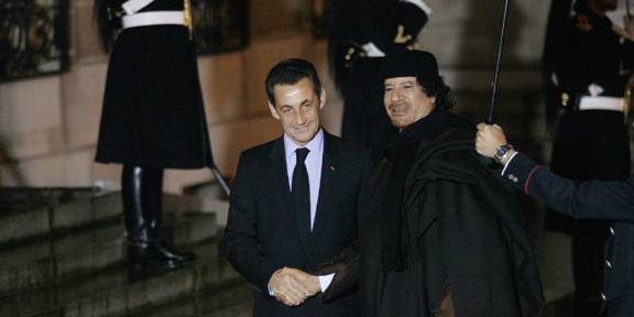 FRANCE - DECEMBER 10:  Mouammar Kadhafi and French President Nicolas Sarkozy arriving for a dinner at the Elysee Palace in Orly, France on December 10th, 2007.  (Photo by Thomas SAMSON/Gamma-Rapho via Getty Images)