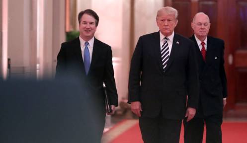 Supreme Court Justice Brett Kavanaugh, President Donald Trump and retired Justice Anthony Kennedy walk into the East Room of the White House for Kavanaugh's ceremonial swearing on October 8, 2018, in Washington, DC.
