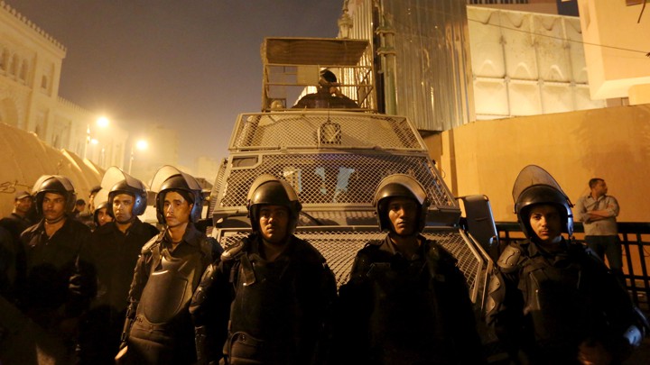 Riot-police officers guard the Cairo Security Directorate from protesters in 2016