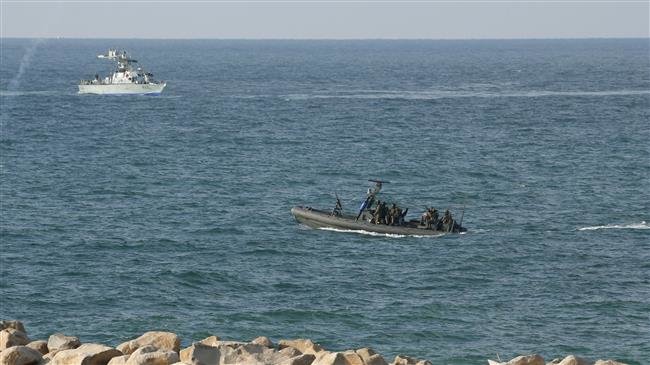 Israeli navy personnel keep watch from boats as Palestinian protesters stage a demonstration in the northern Gaza Strip, on October 8, 2018. (Photo by AFP)

