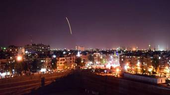 Syrian state media broadcast footage of what it said were its air defences lighting up the night sky [Handout/SANA/AFP]