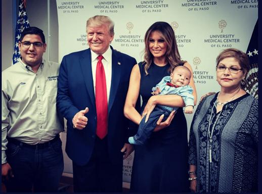 Donald and Melania Trump posing with an infant who's parents were murdered in El Paso
