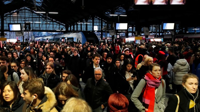 Commuters walk out of a train at the Gare Saint Lazare station in Paris.